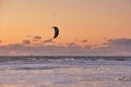 Extreme Sport Kitesurfing, cargo ships on the horizon. Surfer in the sea at Scheveningen at sunset