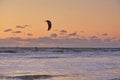 Extreme Sport Kitesurfing, cargo ships on the horizon. Surfer in the sea at Scheveningen at sunset