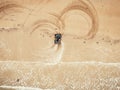 Extreme sport on quad bike beach of sea leaves traces. Aerial top view Royalty Free Stock Photo