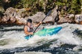 Extreme sport rafting whitewater kayaking. Guy in kayak sails mountain river Royalty Free Stock Photo