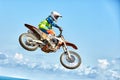 Extreme sports, motorcycle jumping. Motorcyclist makes an extreme jump against the sky. Royalty Free Stock Photo