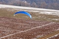 Extreme sports pilot flying with a paramotor engine and a paraglider prepares to land on the ulm runway Royalty Free Stock Photo