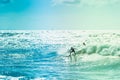 Surfers riding some waves on the sea