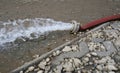 Extreme weather - water being pumped out of a flooded basement