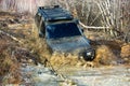 Extreme weekends. A car during a tough off-road competition diving in a muddy pool. Driver competing. Royalty Free Stock Photo