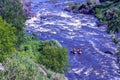 Extreme whitewater rafting trip. A group of people team in kayaks practise traversing the water rapids. Kayaker paddling on the Royalty Free Stock Photo