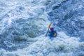 Extreme whitewater rafting trip. A one person in kayak practise traversing the water rapids. Kayaker paddling on the mountain Royalty Free Stock Photo