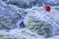 Extreme whitewater rafting trip. A group of people team in kayaks practise traversing the water rapids. Kayaker paddling on the Royalty Free Stock Photo