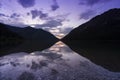 extremely clear water of lake plansee in the tyrolean alps with mountain sillhoutte in the morning