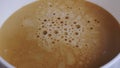 Extremely close up view of white cup. Espresso with bubbles pouring from professional coffee machine. Coffee maker Royalty Free Stock Photo