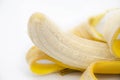 Extremely closeup of a tasty peeled banana fruit over white background