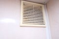 Extremely dirty and dusty white plastic ventilation air grille at home close up, harmful for health, house cleaning concept