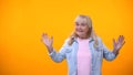 Extremely excited old lady posing on camera, happy with life after retirement