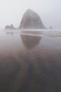 Extremely foggy view of Haystack Rock in Cannon Beach Oregon during the morning Royalty Free Stock Photo