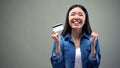 Extremely happy asian woman holding credit card, low interest rate for crediting Royalty Free Stock Photo
