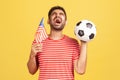 Extremely happy bearded man in striped t-shirt screaming supporting american soccer team on championship, cheering and greeting,