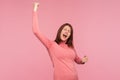 Extremely happy satisfied woman showing yes gesture and screaming celebrating her victory, success, dreams comes true, euphoria Royalty Free Stock Photo