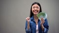 Extremely happy woman holding euros banknotes, good salary, employment concept