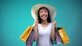 Extremely happy woman in white hat holding many paper bags, shopping addicted Royalty Free Stock Photo