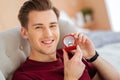 Extremely happy young man posing into camera with proposal ring Royalty Free Stock Photo