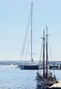 Large sailboats docked, one very large