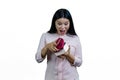 Extremely surprised asian woman is opening a heart-shaped gift box. Royalty Free Stock Photo