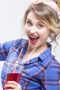 Extremely Surprised Caucasian Blond Woman in Checked Shirt Drinking Red Juice Using Straw