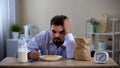 Extremely tired young bachelor sleeping over plate with corn flakes avitaminosis