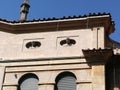 Facade with two busts of statues in the distric Garbatella to Rome in Italy.