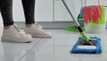 Extrim close up woman washing white kitchen floor with special swob, cleaning service, close-up 4k