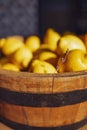 Extrime closeup of vertical view of a wooden bucket full of fresh lemons and sprig of lavender