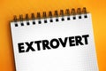 Extrovert are those who enjoy being around other people, text concept on notepad