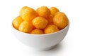 Extruded puffed cheese balls in white ceramic dish isolated on w