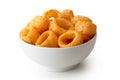 Extruded ring puff corn snack in white ceramic dish isolated on