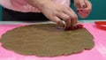 Extruding dough with a heart-shaped shape. Making chocolate chip cookies for Valentine`s Day