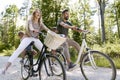 Exuberant family riding bicycles in the forest