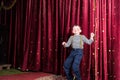 Exuberant little boy performing on stage