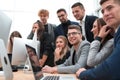 Exultant business team looking at the screen of the office computer