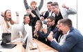 Exultant business team looking at the screen of the office computer Royalty Free Stock Photo