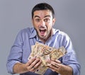 Exultant Young Man holding Banknotes