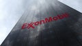 ExxonMobil logo on a skyscraper facade reflecting clouds. Editorial 3D rendering