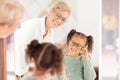Eye care, girl and optometrist help with vision, prescription glasses and eye test for childcare. Child, eyes and