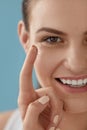 Eye care. Smiling woman with contact eye lens on finger closeup Royalty Free Stock Photo