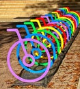 Eye-catching bike rack in the middle of a lush green park with a vibrant selection of colors Royalty Free Stock Photo