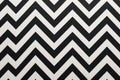 An eye-catching black and white zigzag pattern painted directly on a wall, creating a dynamic and visually appealing design