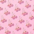 decorative disco balls styled as cherries on a pastel pink background Royalty Free Stock Photo