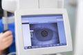 Eye diagnosis on eye test machine with screen.