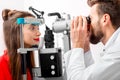 Eye doctor checking vision Royalty Free Stock Photo