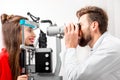 Eye doctor checking vision Royalty Free Stock Photo