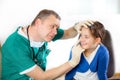 Eye doctor examining young girl patient Royalty Free Stock Photo